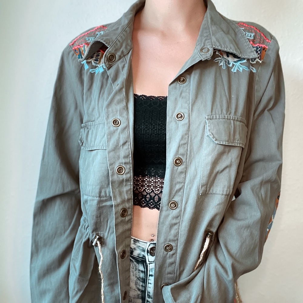 Embroidered green denim jacket with knitted back.